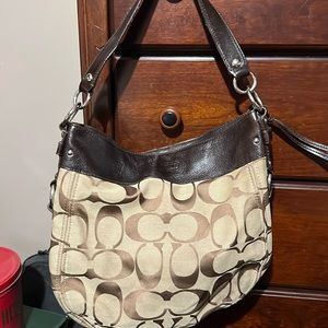 Coach shoulder bag tan with brown trim and signature Coach “C” logo